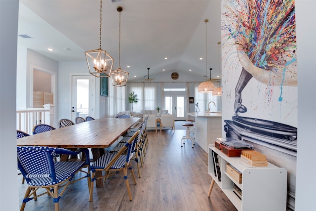 dining space featuring french doors, wood-type flooring, sink, vaulted ceiling, and ceiling fan