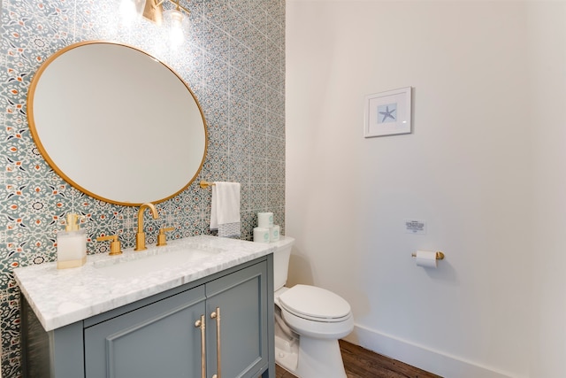 bathroom with vanity, hardwood / wood-style flooring, and toilet