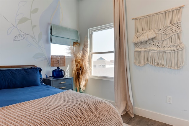 bedroom with dark hardwood / wood-style flooring