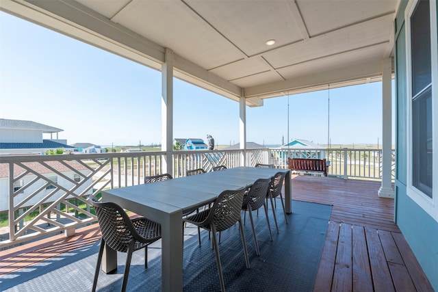 wooden terrace featuring a water view