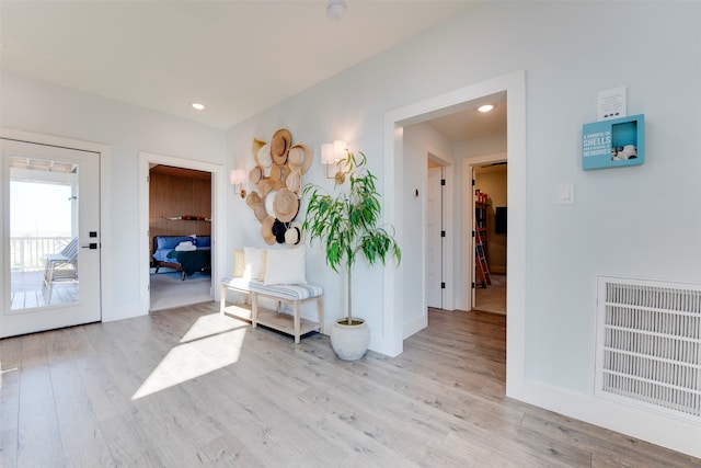 corridor with light hardwood / wood-style flooring