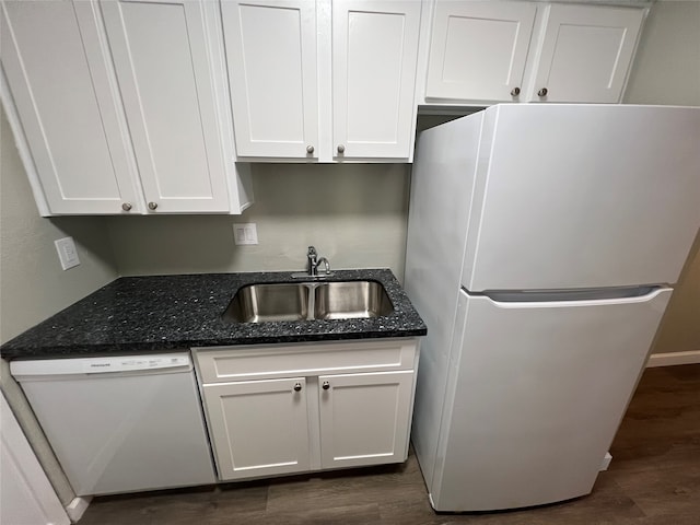 kitchen featuring white cabinetry, sink, dark wood-type flooring, dark stone countertops, and white appliances