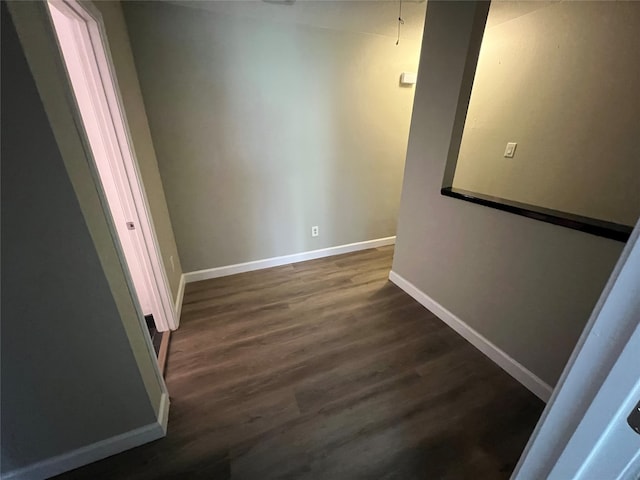 corridor with dark hardwood / wood-style floors