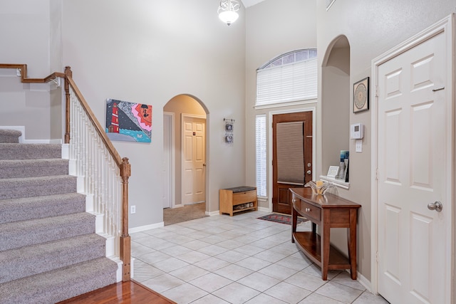 tiled entrance foyer with a high ceiling