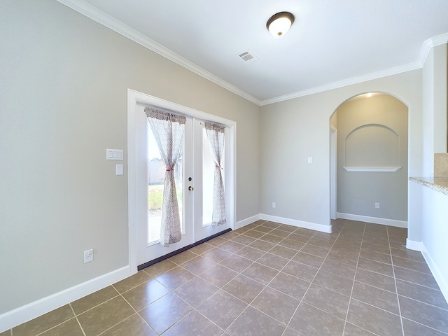 tiled spare room with crown molding and french doors