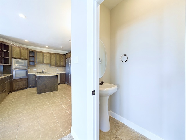 bathroom with backsplash and tile patterned flooring