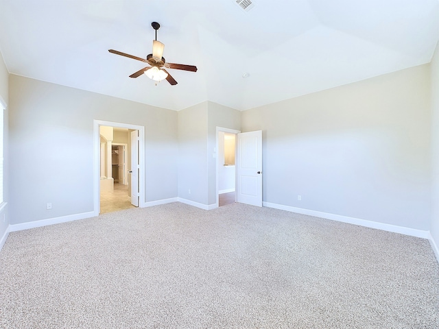 empty room with light carpet, lofted ceiling, and ceiling fan