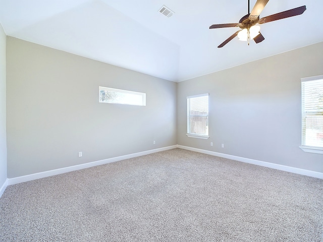 unfurnished room featuring ceiling fan, carpet, and vaulted ceiling