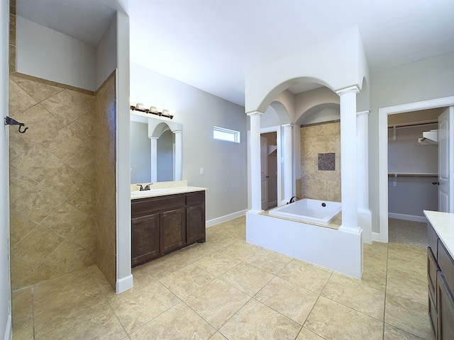 bathroom featuring vanity, ornate columns, tile patterned floors, and plus walk in shower