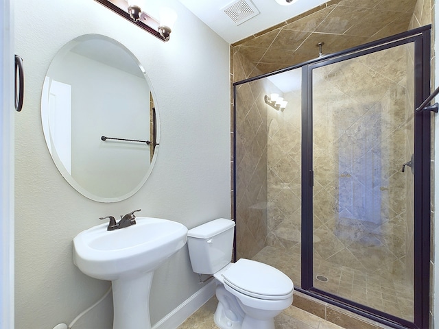 bathroom featuring toilet and an enclosed shower