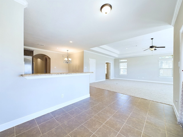 empty room with ornamental molding, carpet flooring, and ceiling fan with notable chandelier