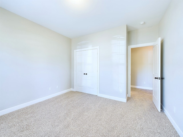 unfurnished bedroom with a closet and carpet flooring