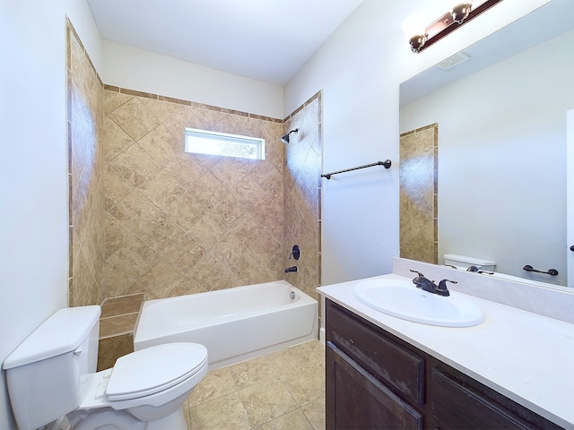 full bathroom featuring toilet, tiled shower / bath combo, vanity, and tile patterned floors