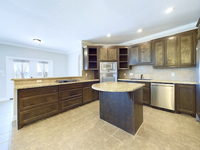 kitchen with a center island, dark brown cabinetry, stainless steel appliances, and sink