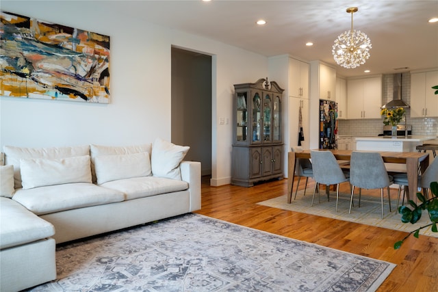 living room featuring a chandelier and light hardwood / wood-style flooring