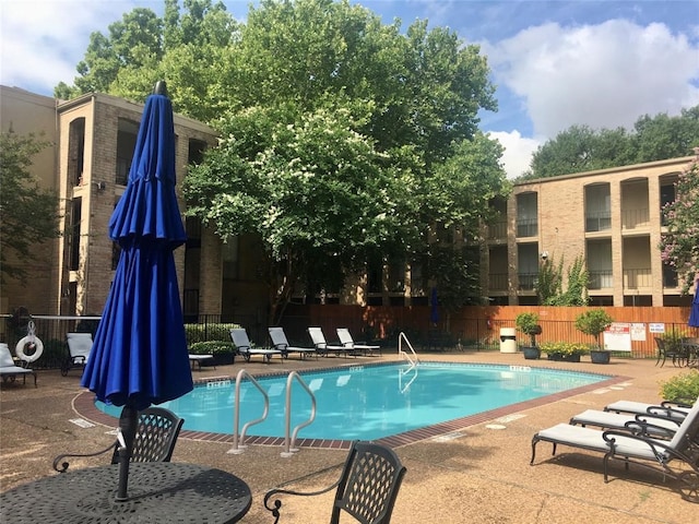 view of swimming pool featuring a patio area