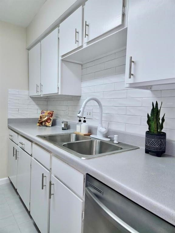 4641 Wild Indigo St Unit 449, Houston, TX 77027 - kitchen with dishwasher, a sink, light countertops, and white cabinets