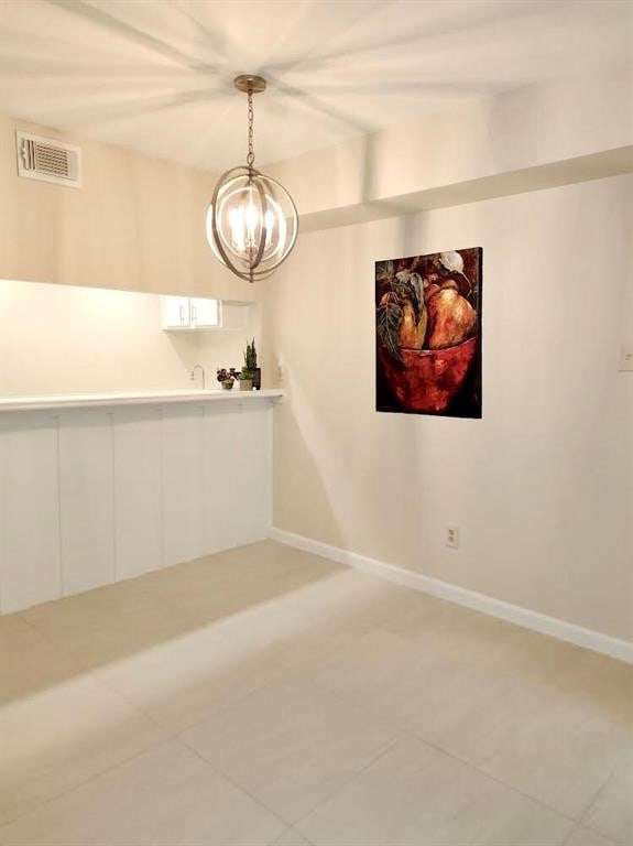 unfurnished room with tile patterned floors