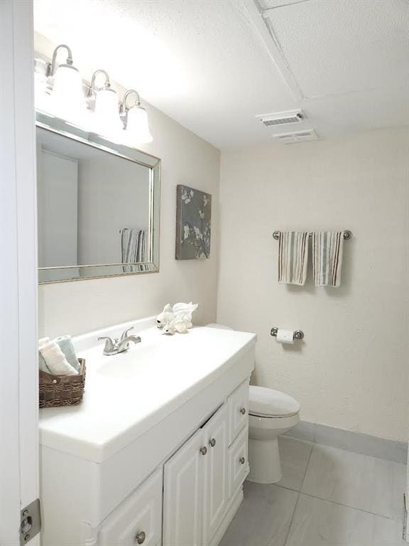 4641 Wild Indigo St Unit 449, Houston, TX 77027 - half bathroom featuring vanity, toilet, tile patterned floors, and baseboards