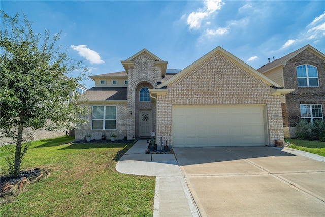 view of front facade with a front yard and a garage