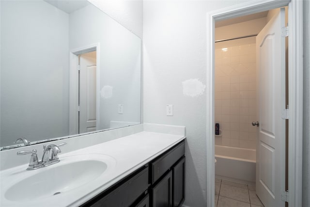 bathroom featuring tiled shower / bath, tile patterned floors, and vanity