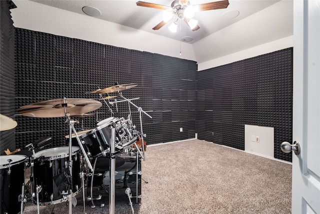 miscellaneous room featuring ceiling fan, vaulted ceiling, and carpet