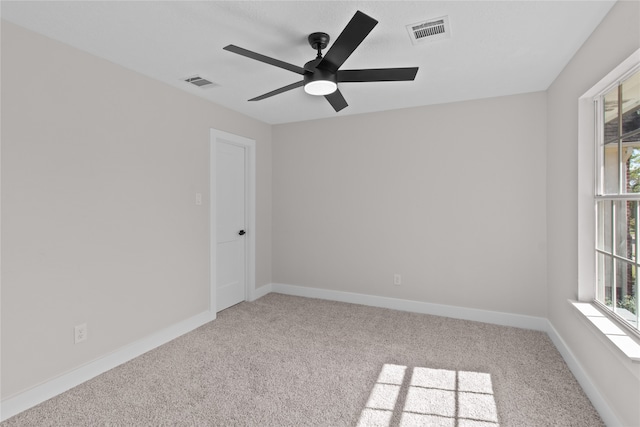 carpeted empty room featuring ceiling fan