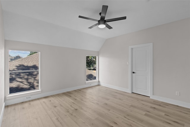 spare room with light wood-type flooring, ceiling fan, and lofted ceiling