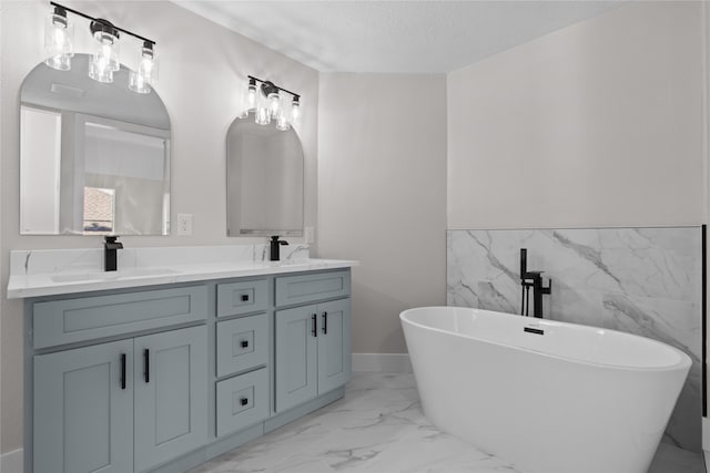 bathroom featuring vanity, a textured ceiling, a tub to relax in, and tile walls