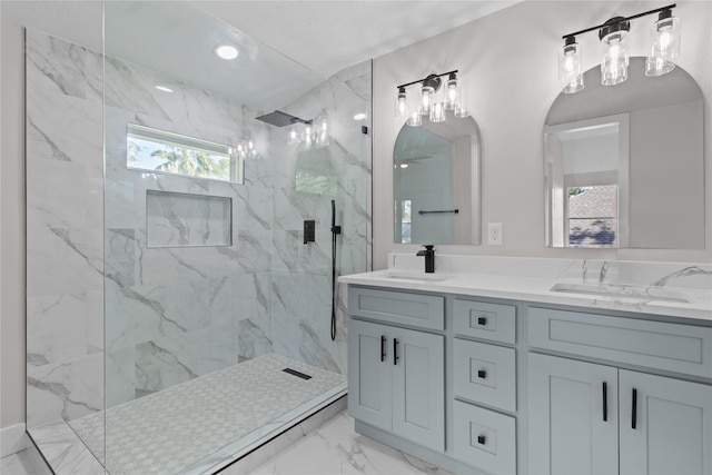 bathroom featuring ceiling fan, vanity, and tiled shower