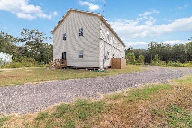 view of side of property with a yard