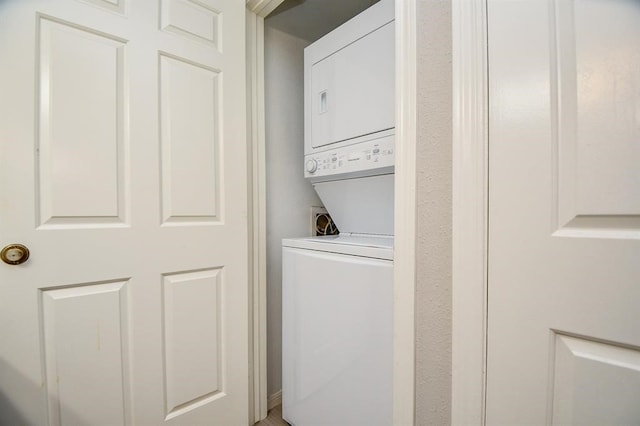 laundry area with stacked washer / drying machine