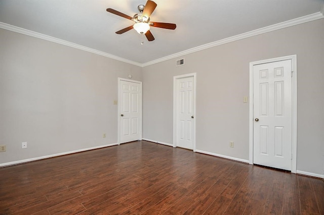 empty room featuring crown molding, dark wood-type flooring, and ceiling fan