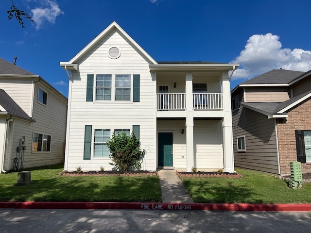 view of front of property with a front lawn and a balcony