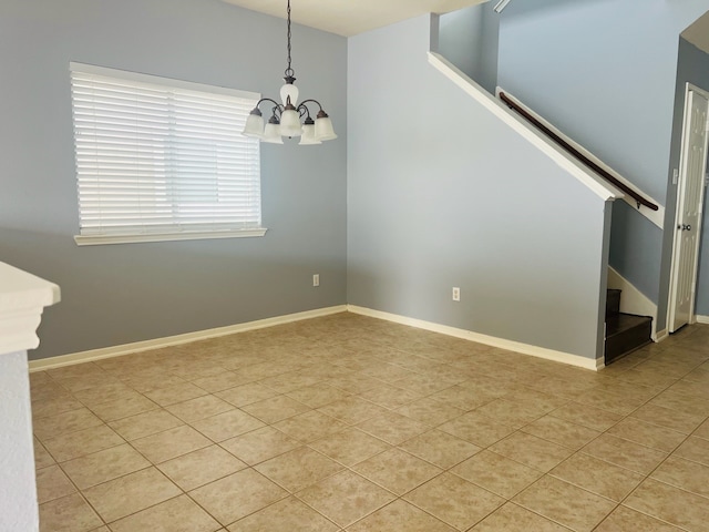 spare room with a chandelier