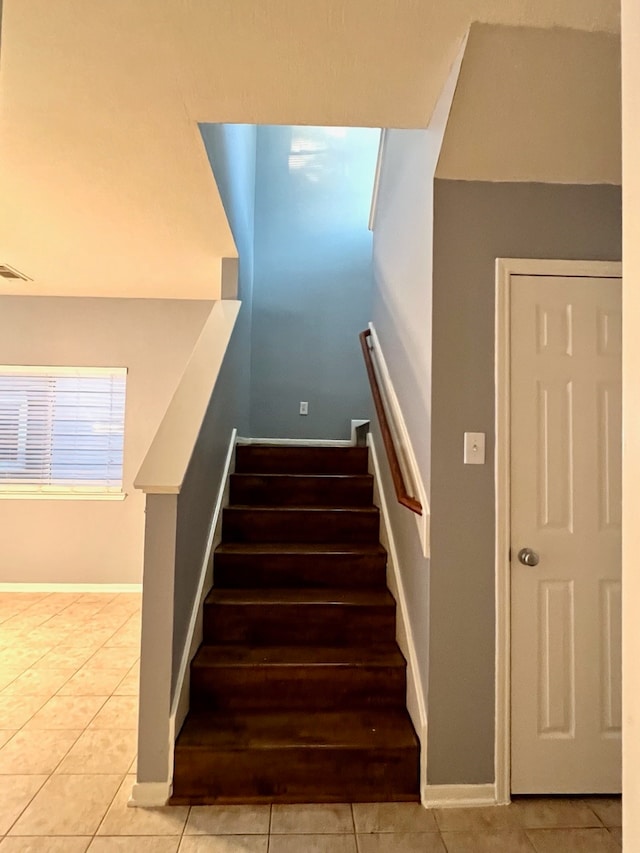 staircase with tile patterned flooring