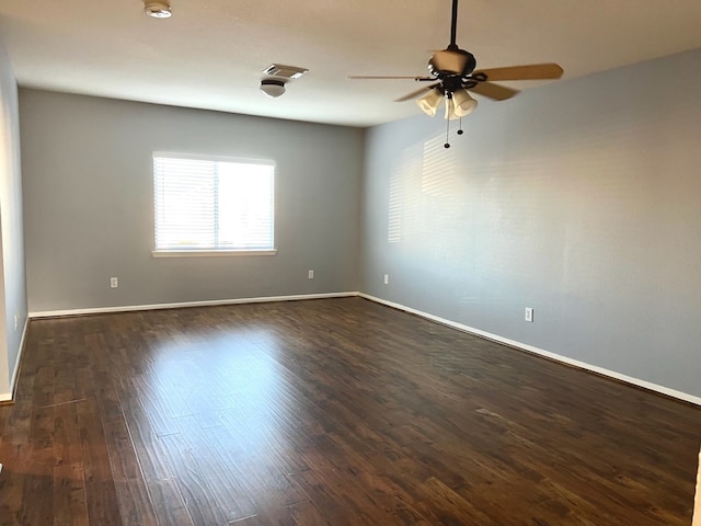 empty room featuring ceiling fan and dark hardwood / wood-style floors