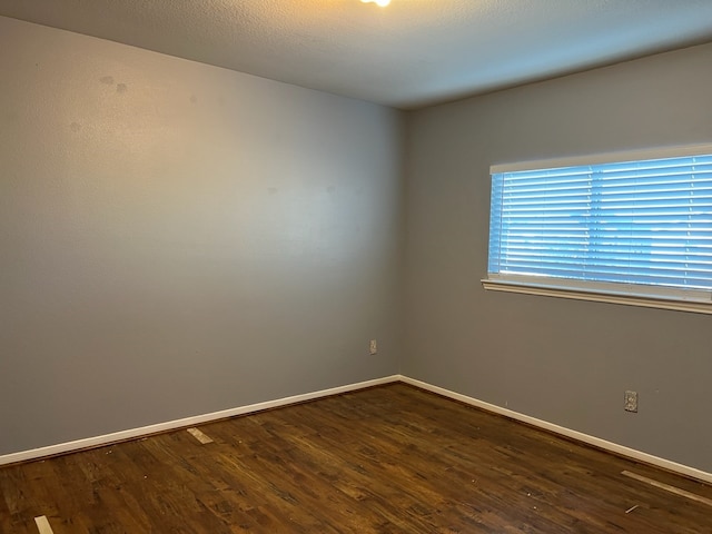 unfurnished room with dark hardwood / wood-style floors