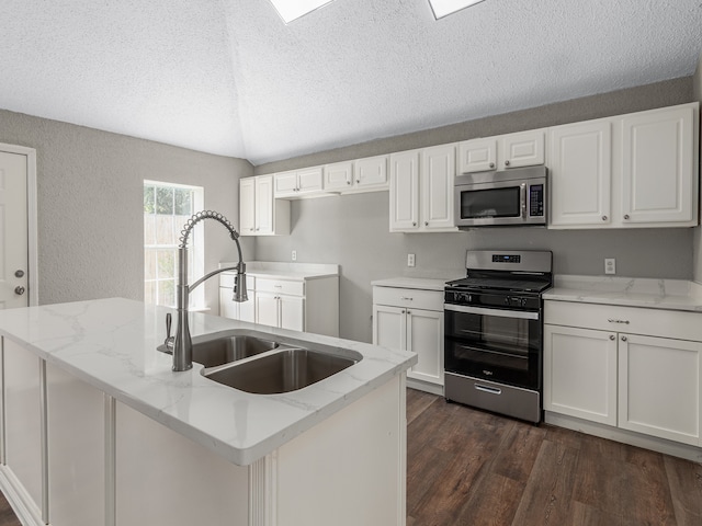 kitchen with stainless steel appliances, white cabinetry, light stone countertops, sink, and dark wood-type flooring