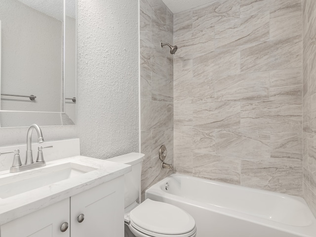 full bathroom with toilet, vanity, tiled shower / bath, and a textured ceiling