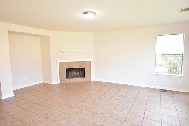 unfurnished living room featuring light tile patterned floors and a fireplace