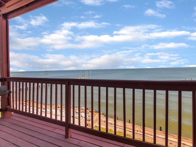 wooden terrace with a water view and a beach view