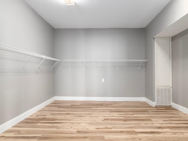 spacious closet featuring wood finished floors and visible vents