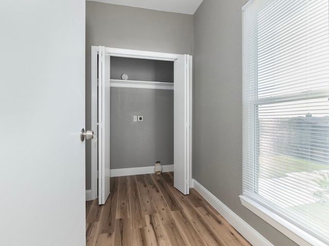 clothes washing area featuring electric dryer hookup and hardwood / wood-style floors