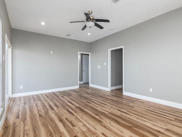 spare room featuring baseboards, recessed lighting, light wood-style floors, and ceiling fan