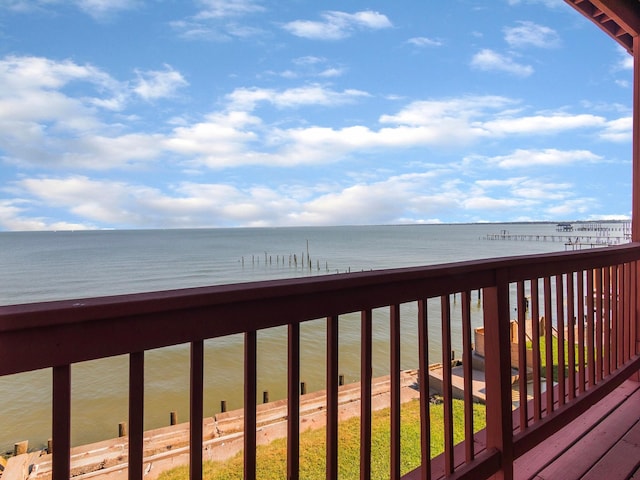 wooden terrace featuring a water view