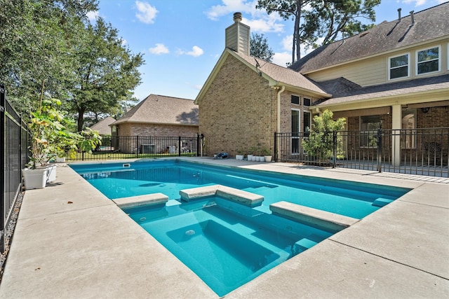 view of swimming pool featuring an in ground hot tub and a patio