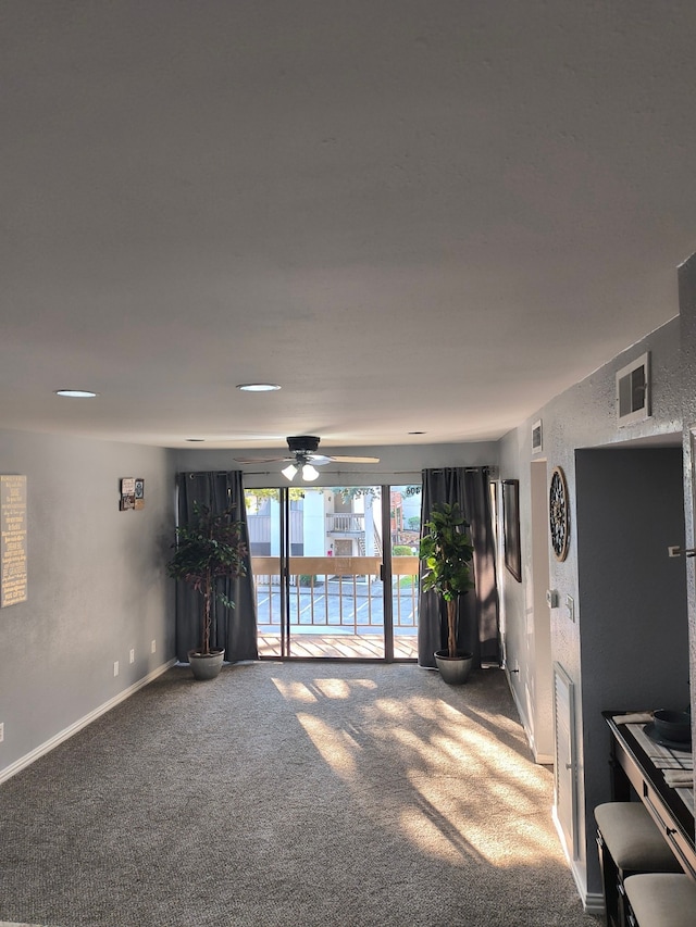 interior space featuring ceiling fan and carpet floors