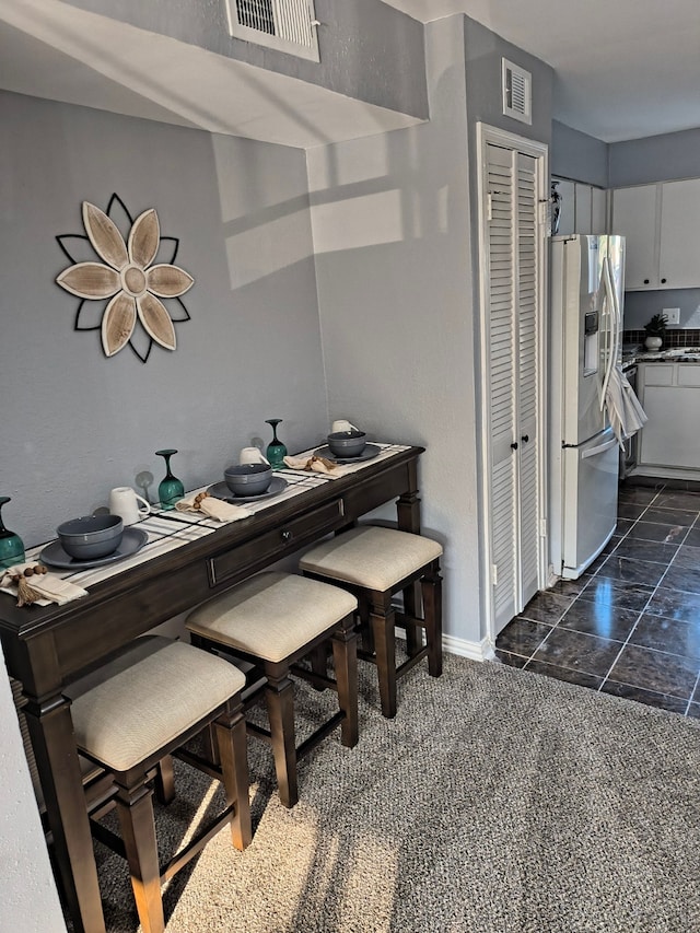 12100 Melville Dr Unit 406D, Montgomery, TX 77356 - dining space with baseboards and dark marble finish floors