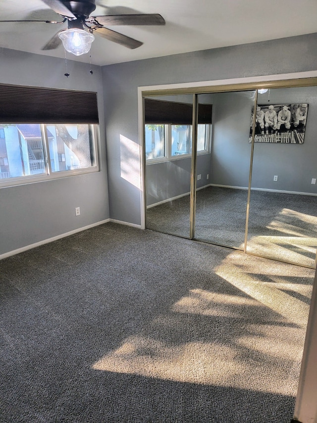 unfurnished bedroom featuring ceiling fan, a closet, and carpet